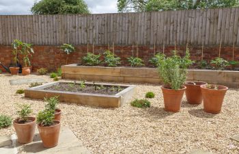 Garden with wooden raised beds and timber fencing., 